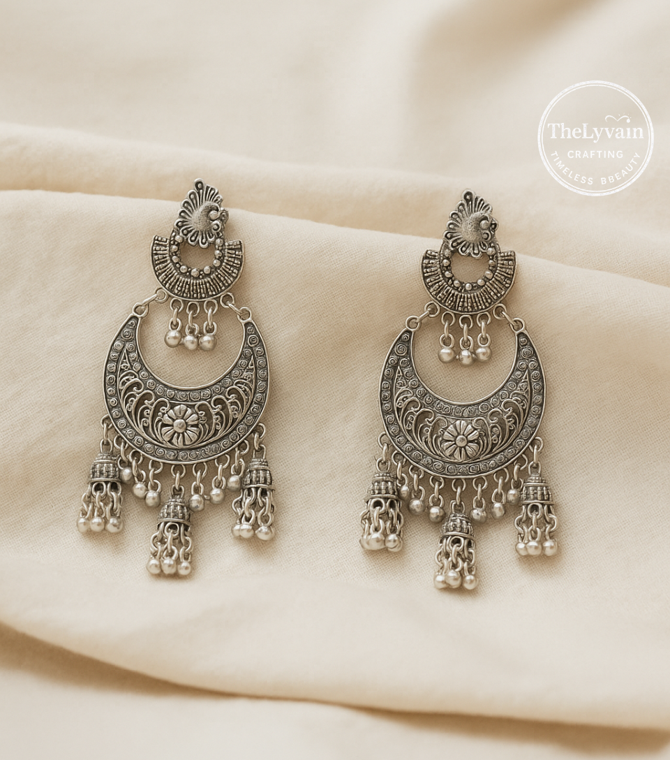 Oxidized silver chandbali earrings with floral engraving and bead drop hangings by TheLyvain