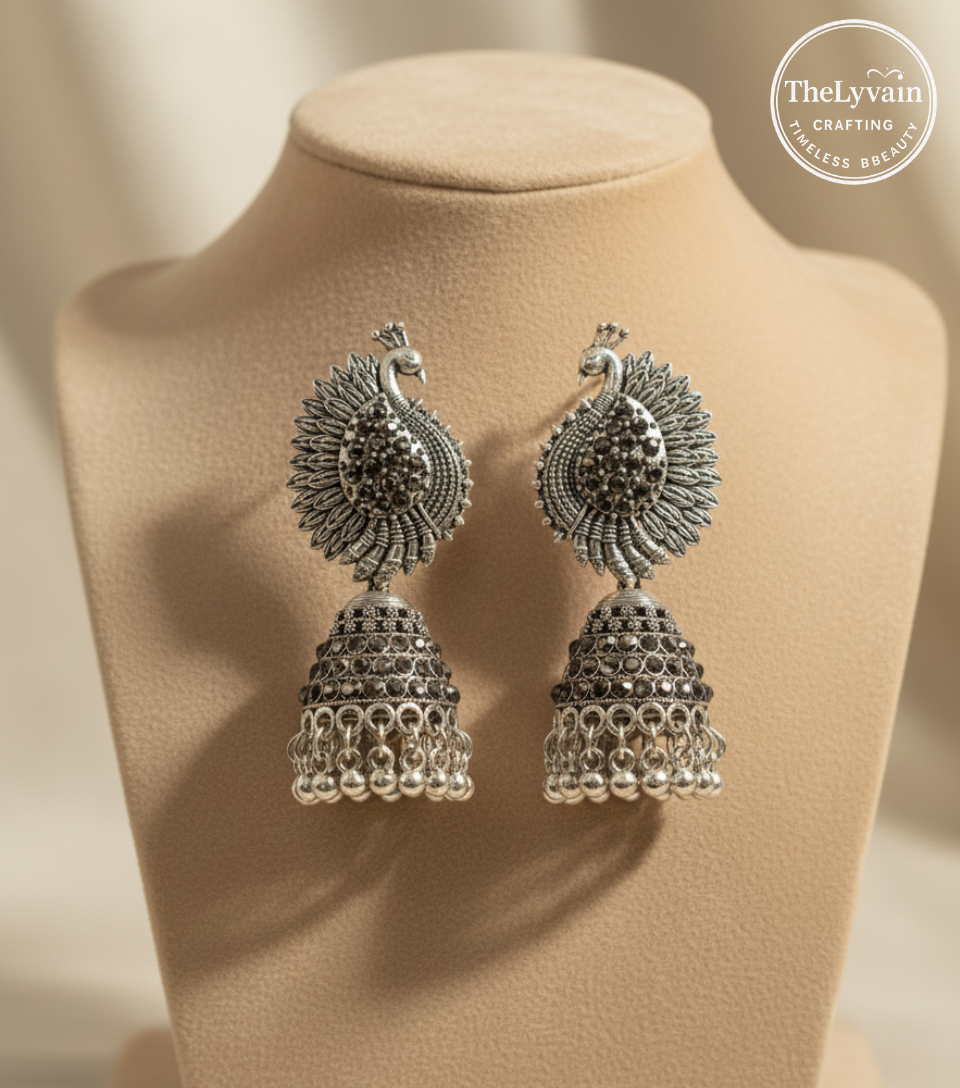 Oxidized silver peacock jhumka earrings with detailed feathers and hanging beads by TheLyvain