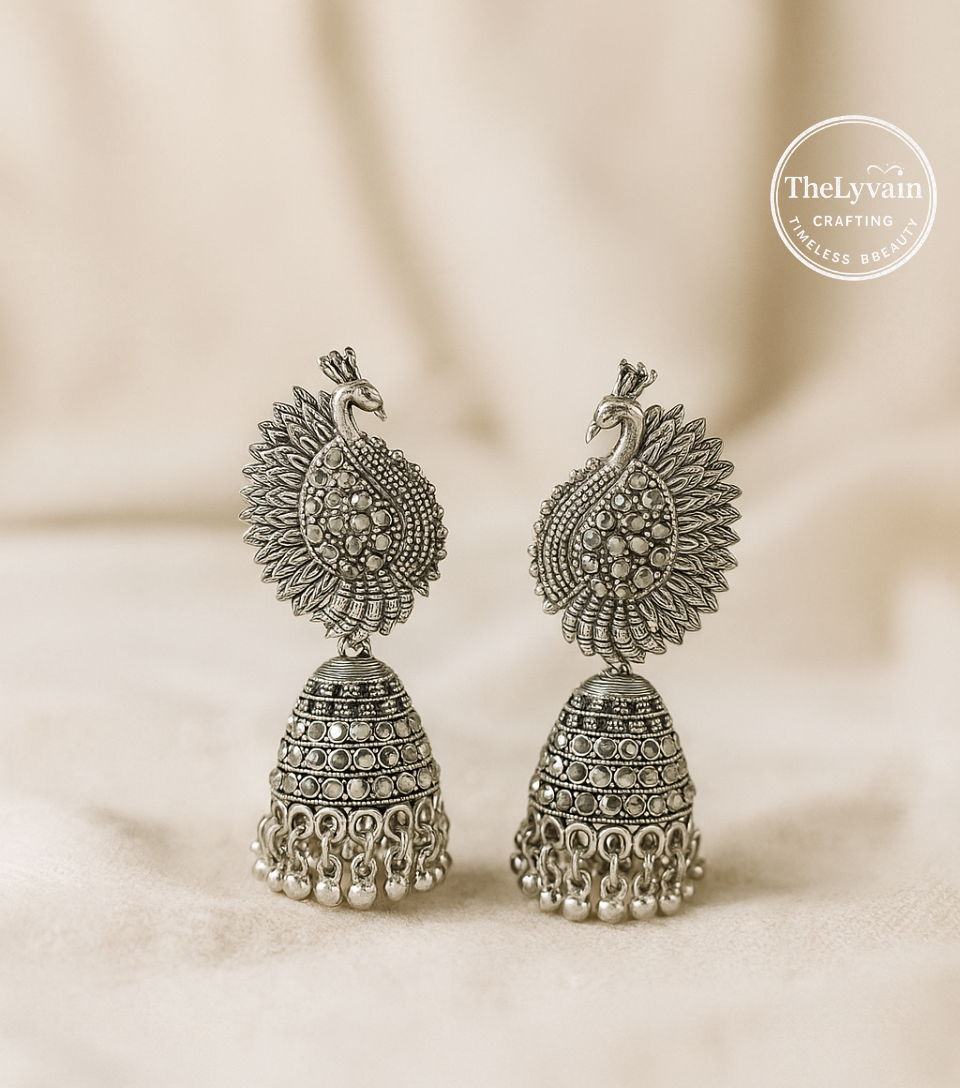 Oxidized silver jhumka earrings with vintage-style peacock design and hanging beads by TheLyvain