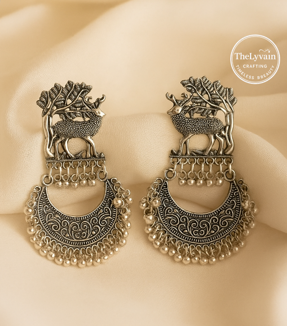 Oxidized silver chandbali earrings with deer and tree motif and hanging beads by TheLyvain